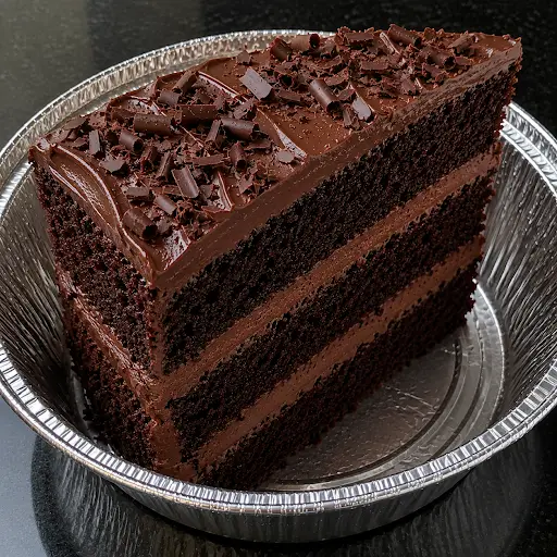 Fresh Chocolate Cake Slice with rich chocolate frosting served at Halal Crispy Bites in Baltimore