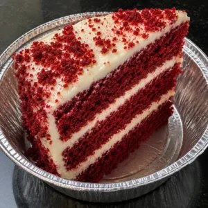 Fresh Red Velvet Cake Slice with cream cheese frosting served at Halal Crispy Bites in Baltimore