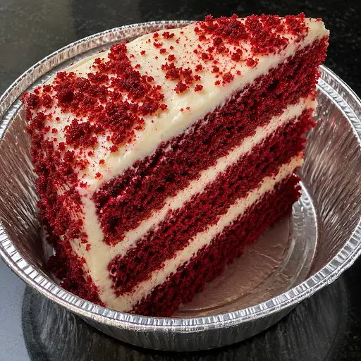 Fresh Red Velvet Cake Slice with cream cheese frosting served at Halal Crispy Bites in Baltimore